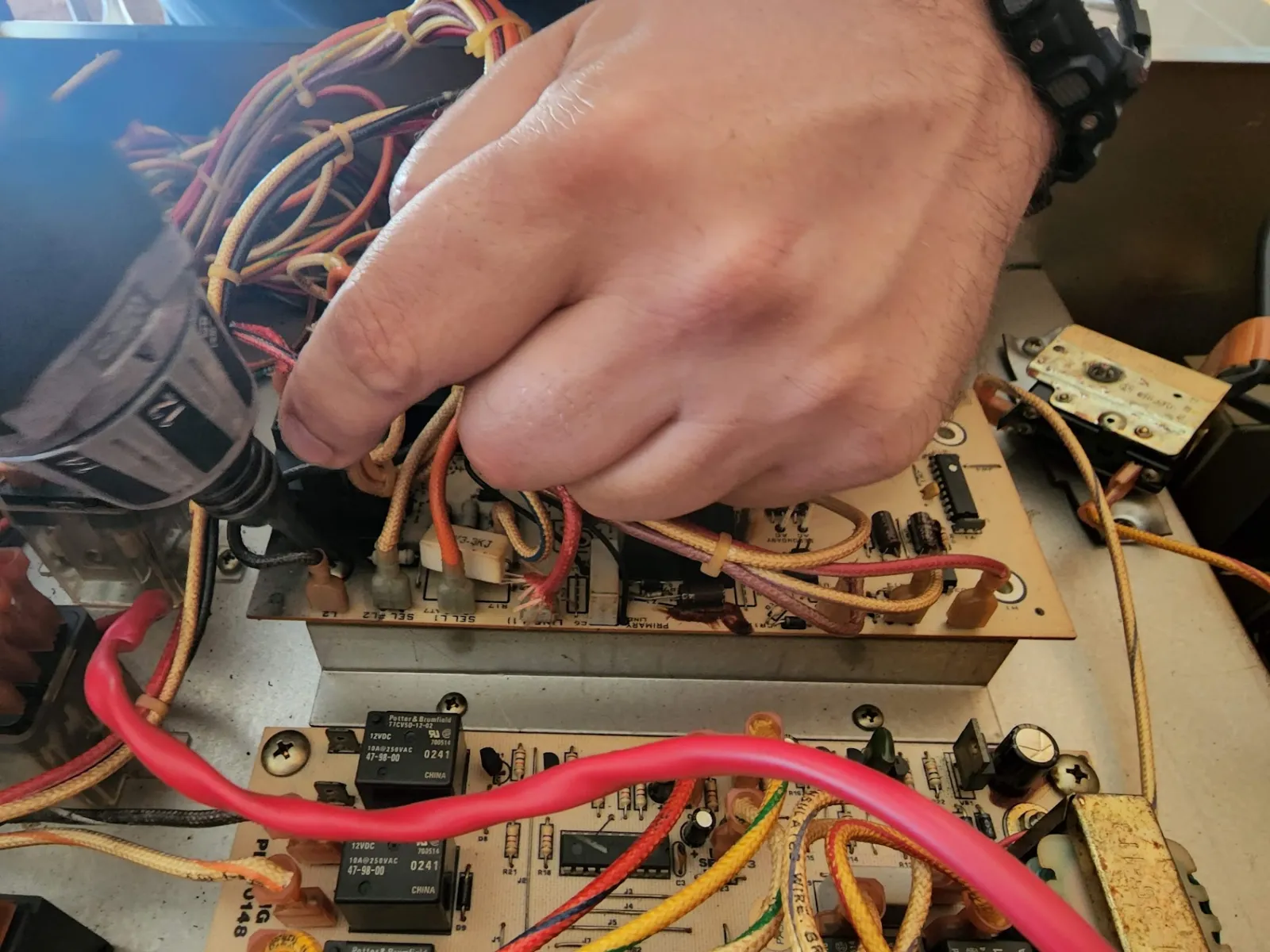 Technician diagnosing the electronic control board of a Sub-Zero refrigerator