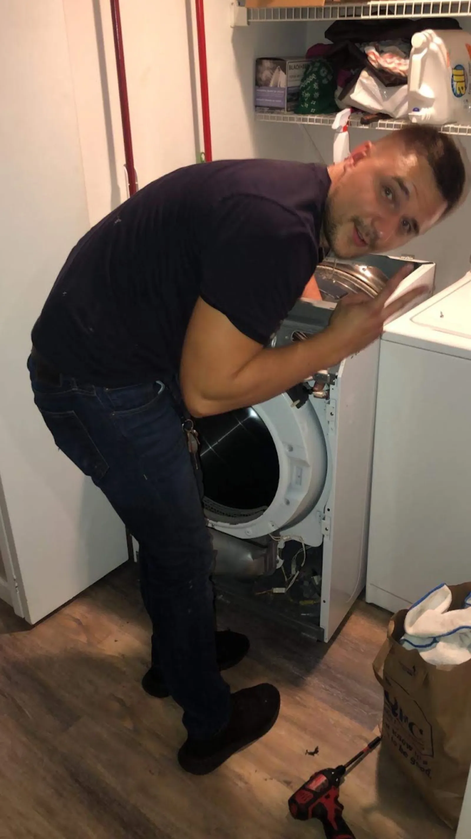 Technician diagnosing a dryer that isn't heating