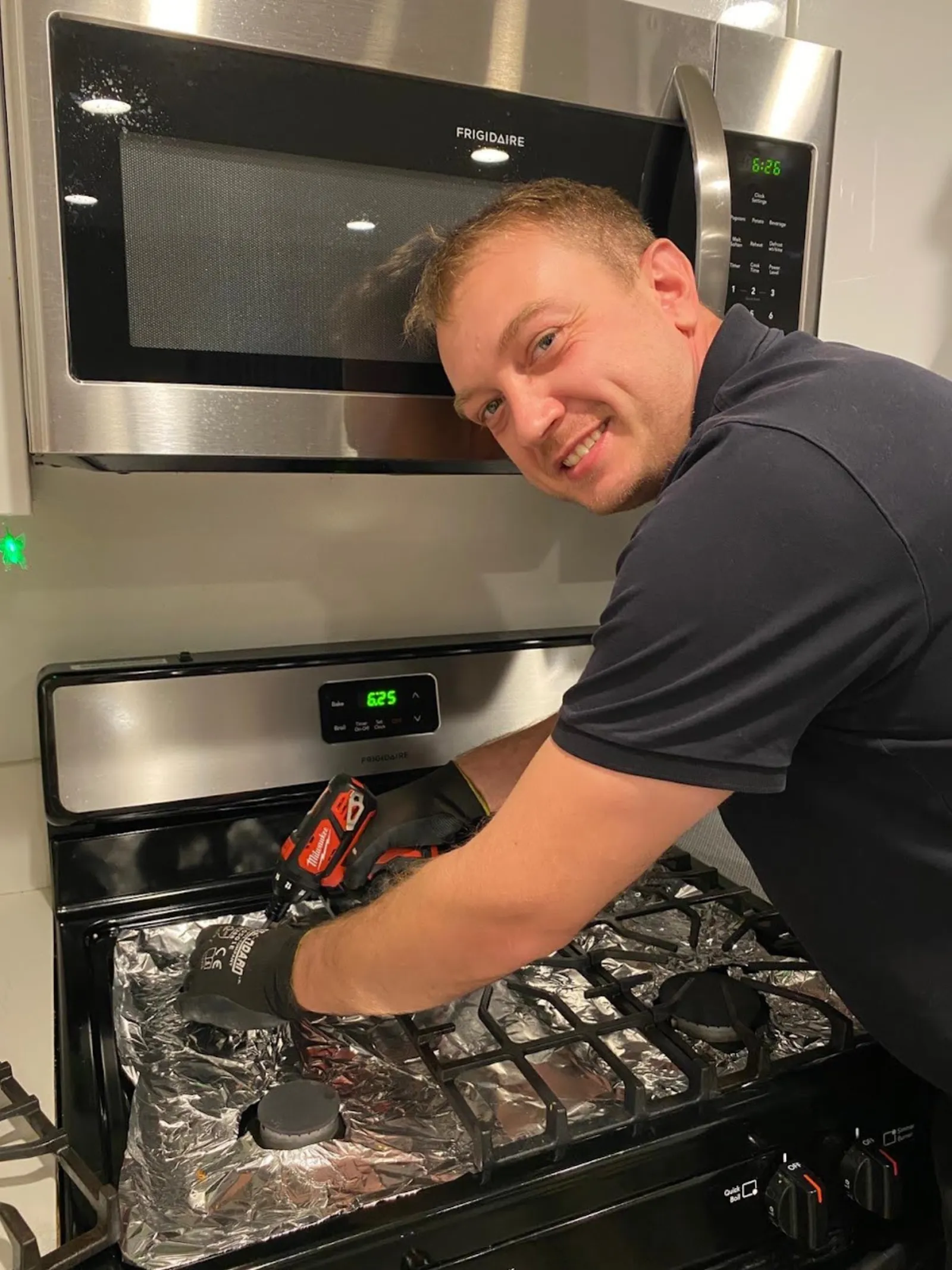 Technician repairing a range burner that won't light